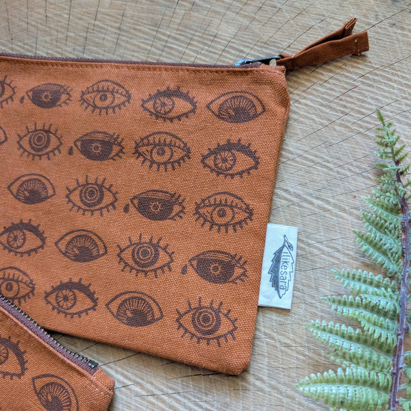 ilikesara | art + goods - Zippered pouch | eyeball - rust orange eye blockprint pencil, supply, makeup bag with waterproof lining