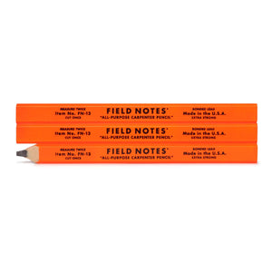 Three orange Field Notes carpenter pencils on a white background
