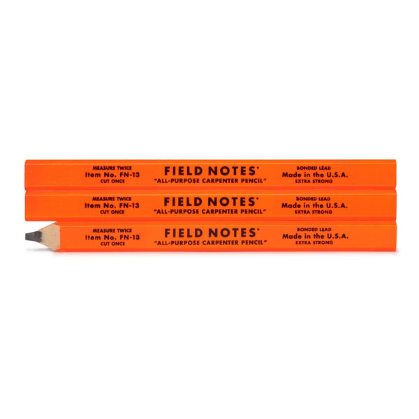 Three orange Field Notes carpenter pencils on a white background