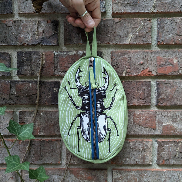 ilikesara | art + goods - Zippered pouch | stag beetle - green insect/bug pencil, supply, makeup bag with waterproof lining